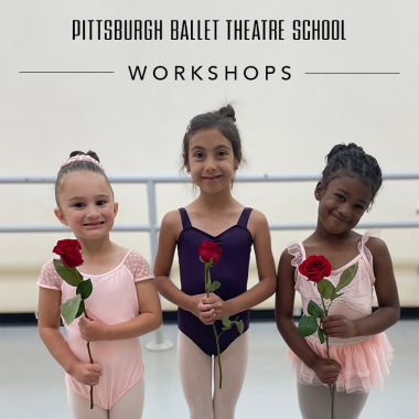 Three children in leotards and ballet buns stand together holding roses from a children's workshop.