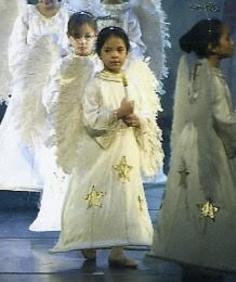 Young Cecilia in a white angel costume