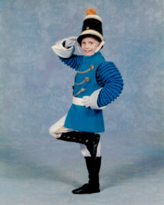 Young Caitlyn in a blue soldier uniform